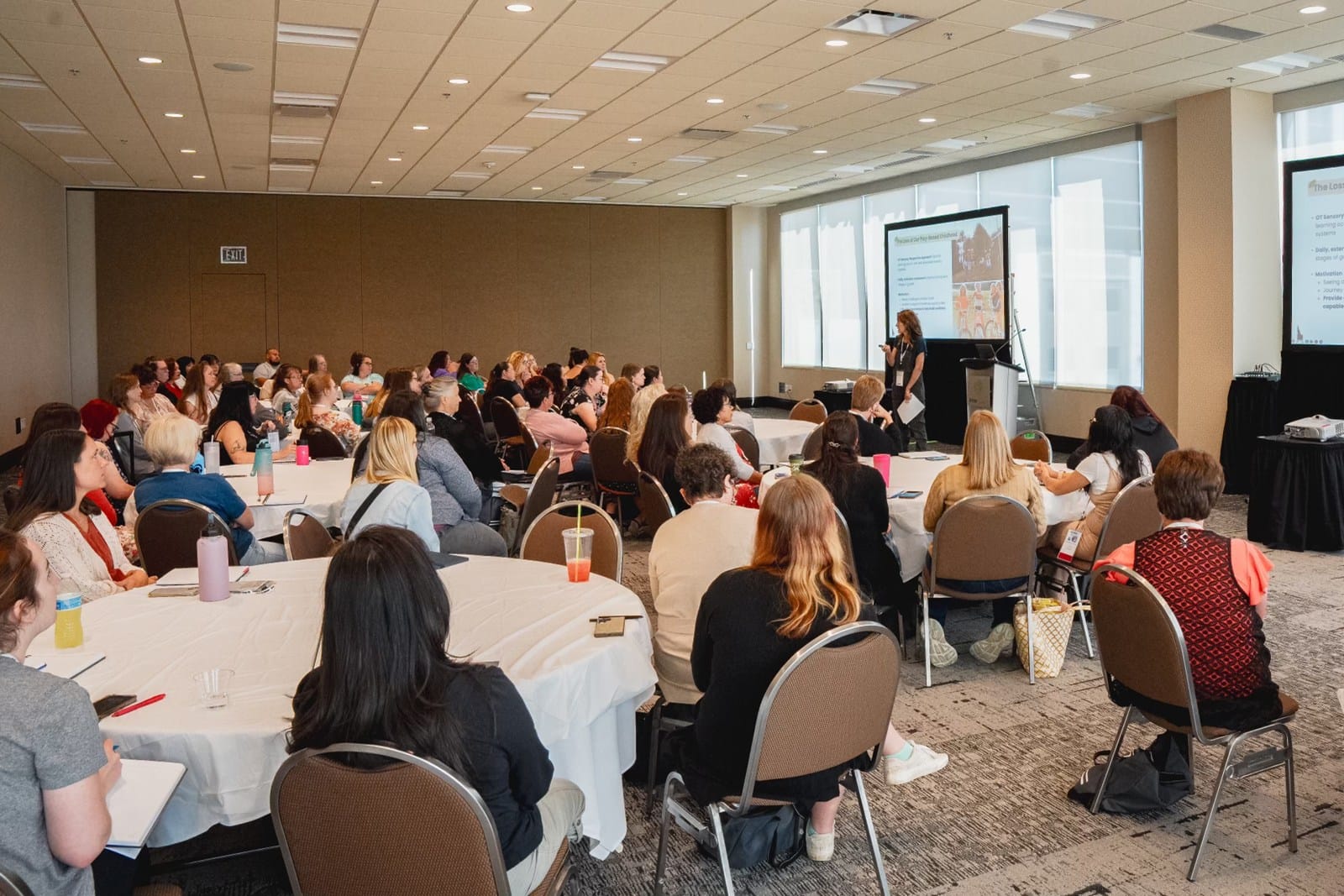 A seated conference audience listening to a presentation