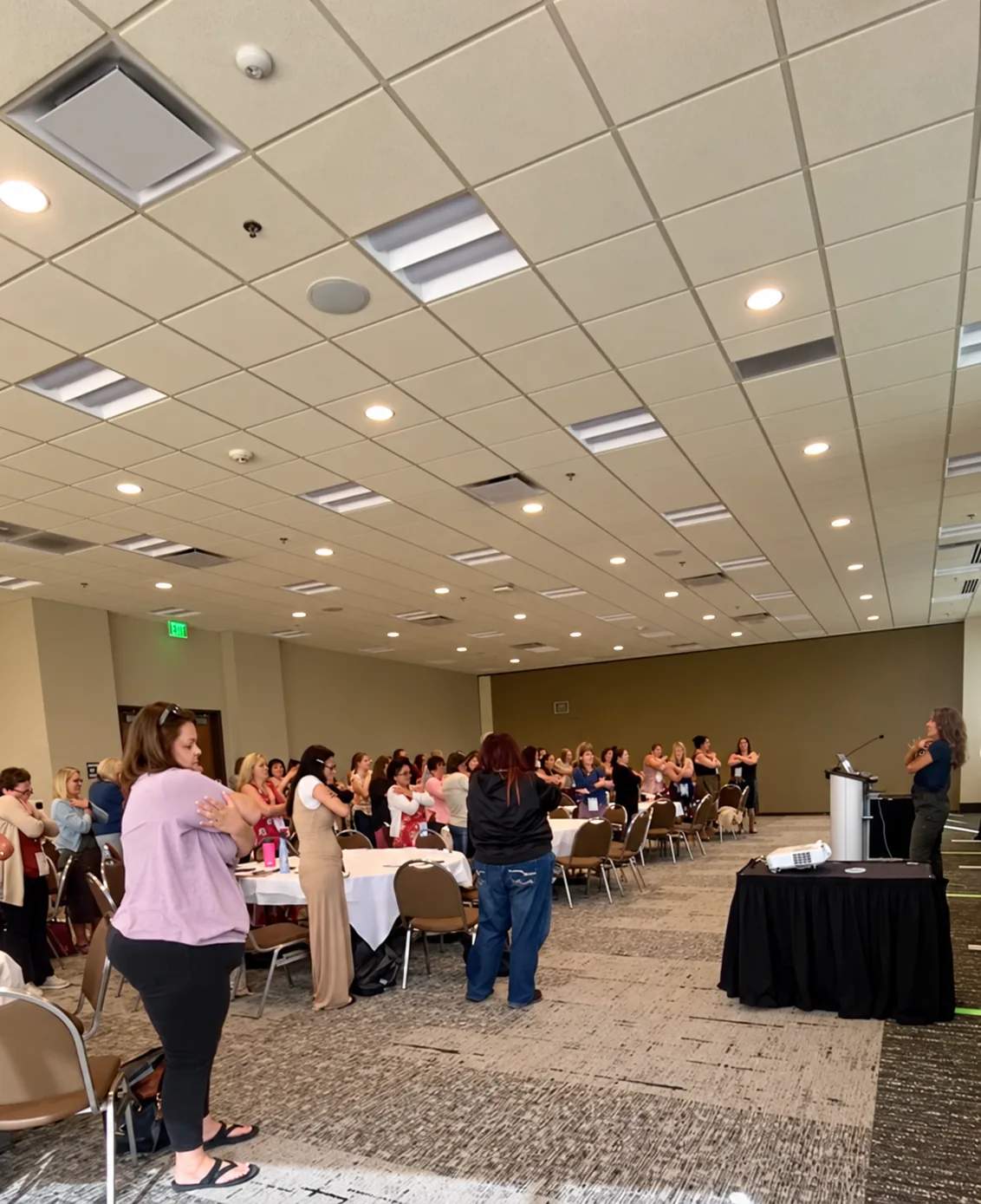 Participants joining a standing activity during a workshop
